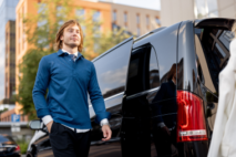 man-in-casual-wear-stands-near-minivan-taxi-2023-11-27-05-30-38-utc 1